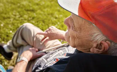 An older man sits outside