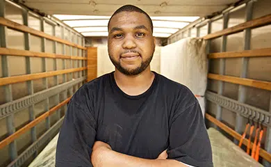 A man stands in a delivery truck