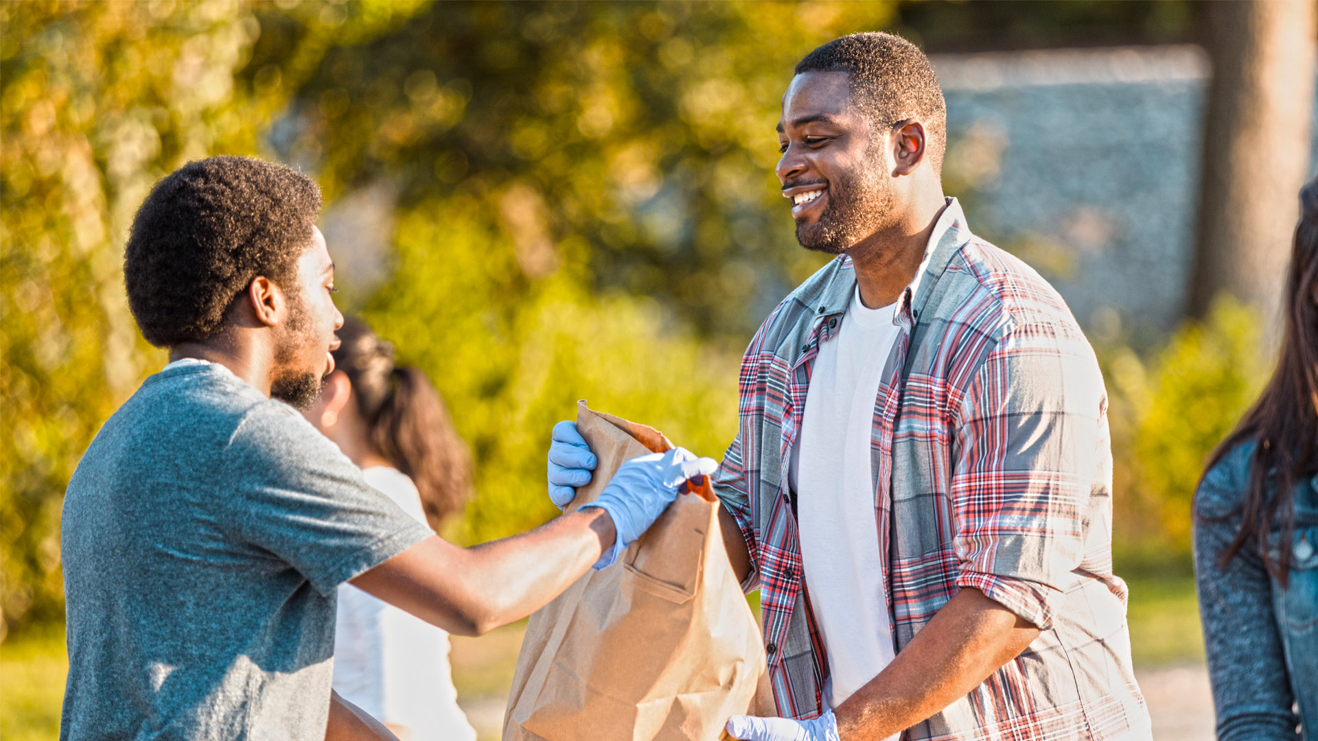 volunteer helping handing a bag of supplies