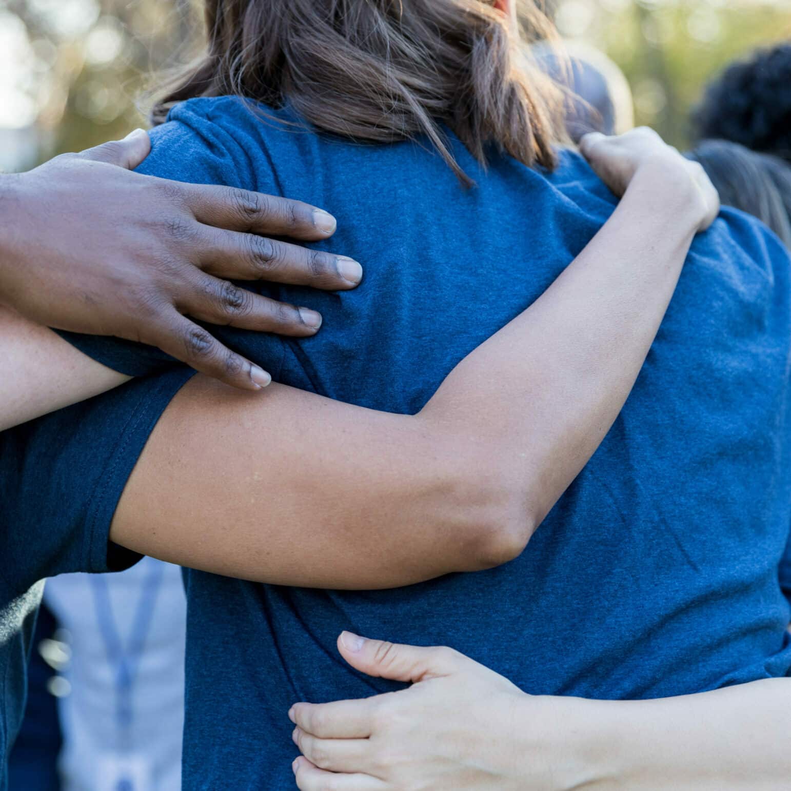 A team comes in for a group hug