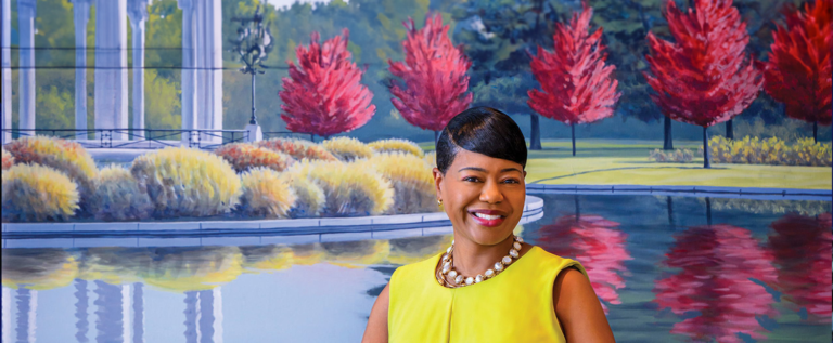 United Way President and CEO Michelle Tucker in front of artwork