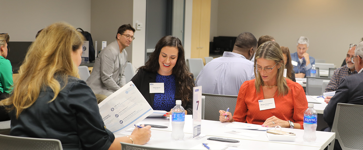 Women and men sit at a United Way Leadership event. 